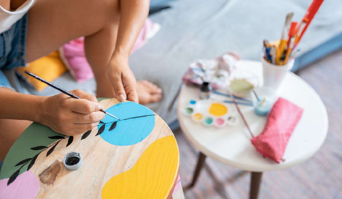 Wood Crafting at Home independence Woman painting a wooden bench at home