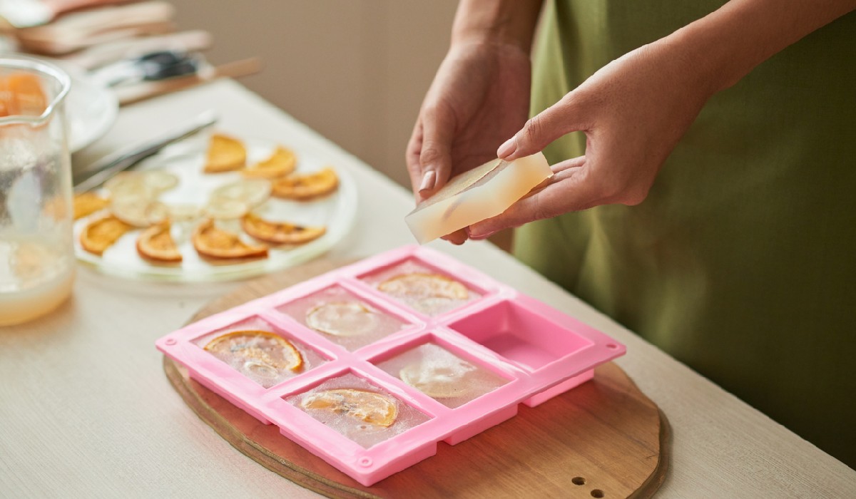 Woman taking soap bars out of plastic form