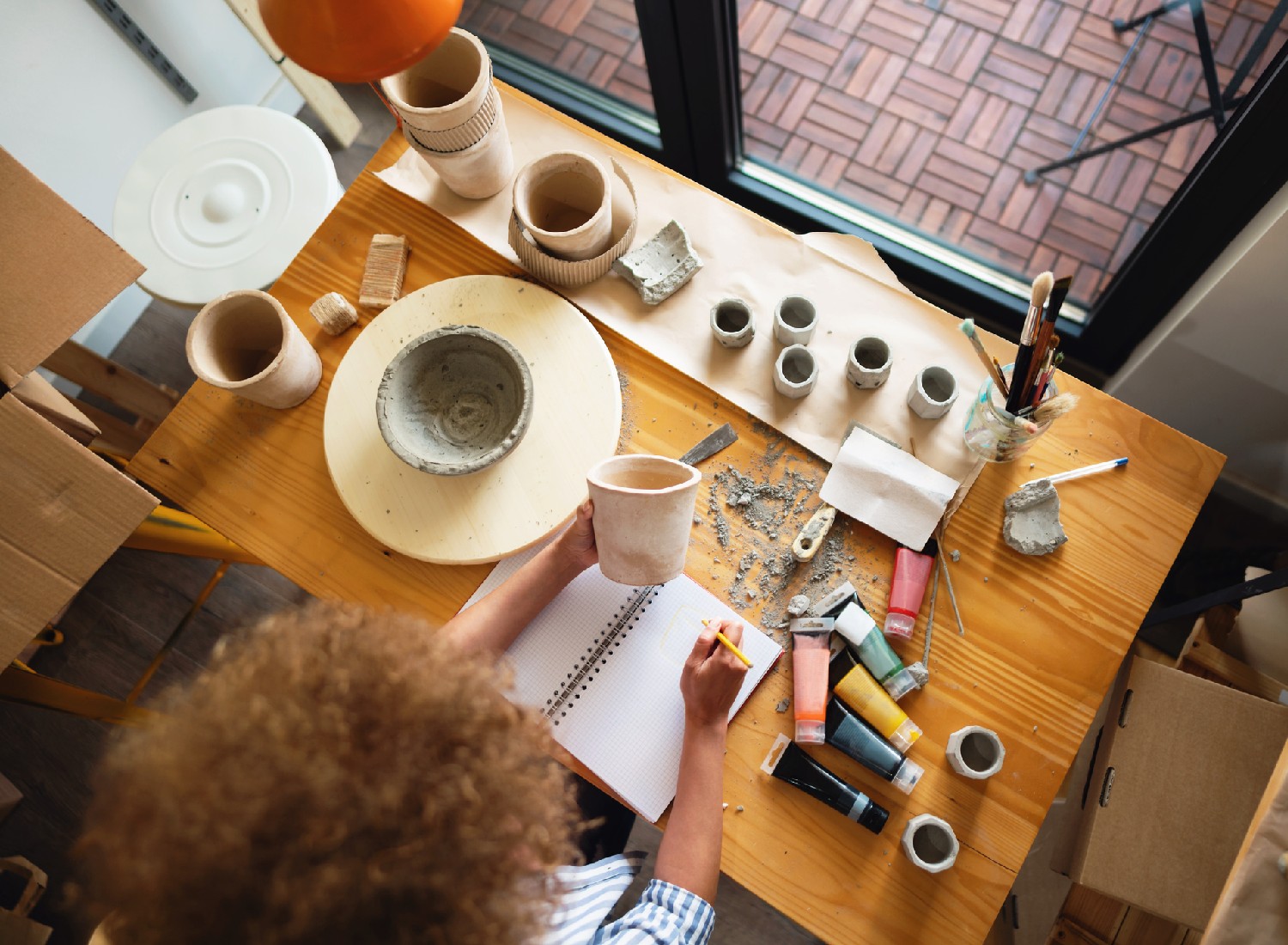 home-pottery-projects independence High angle view of an unrecognizable woman working at her desk in a pottery studio