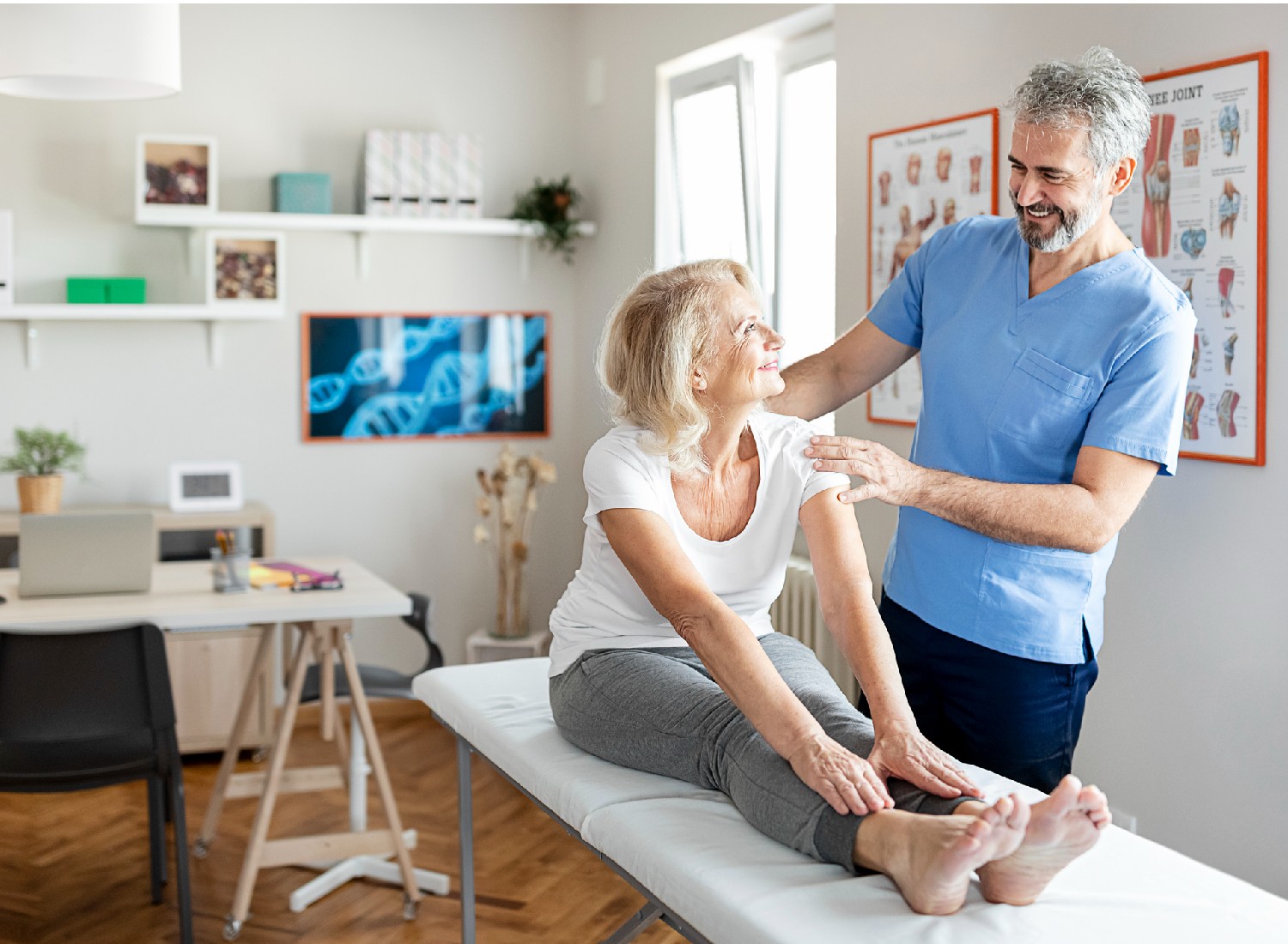 Modern rehabilitation physiotherapy worker with a senior female client.