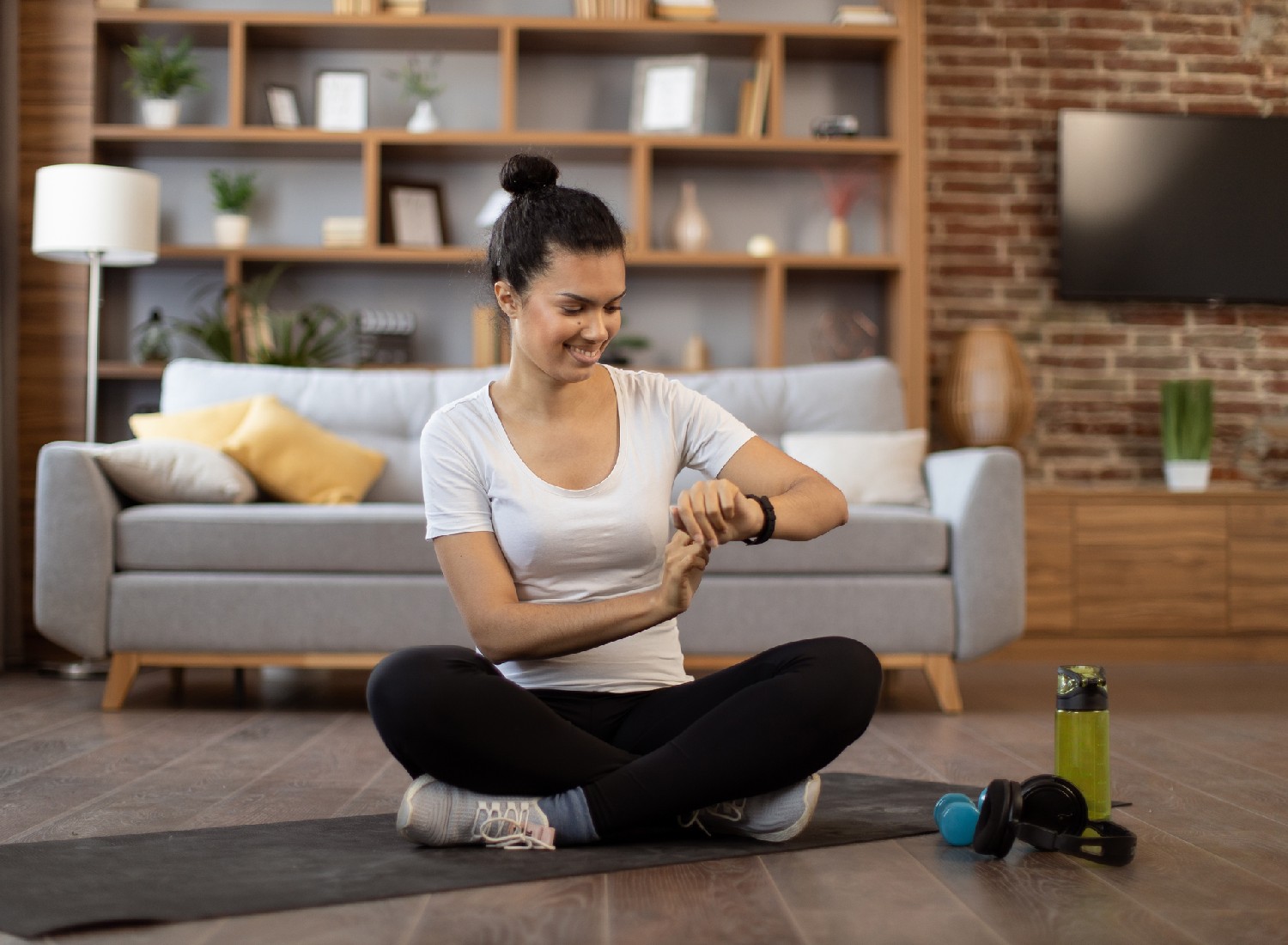 Young active woman using activity tracker for being organized and on schedule.