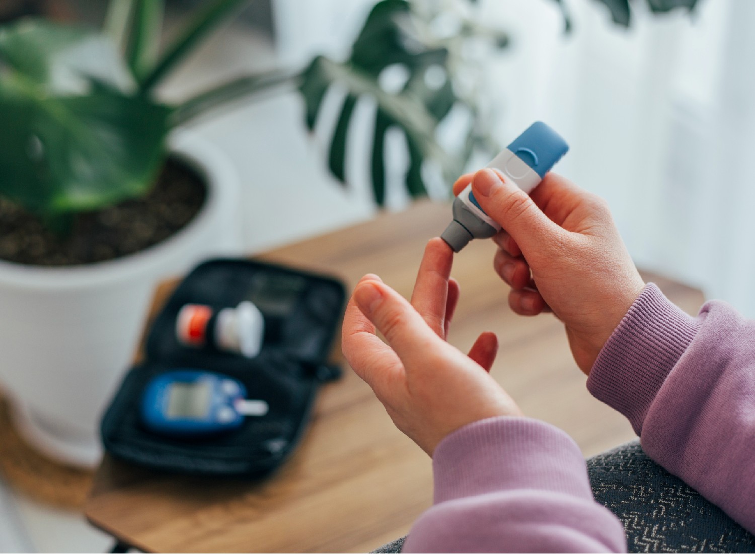reverse-prediabetes the-independence Woman doing blood sugar test at home, close up