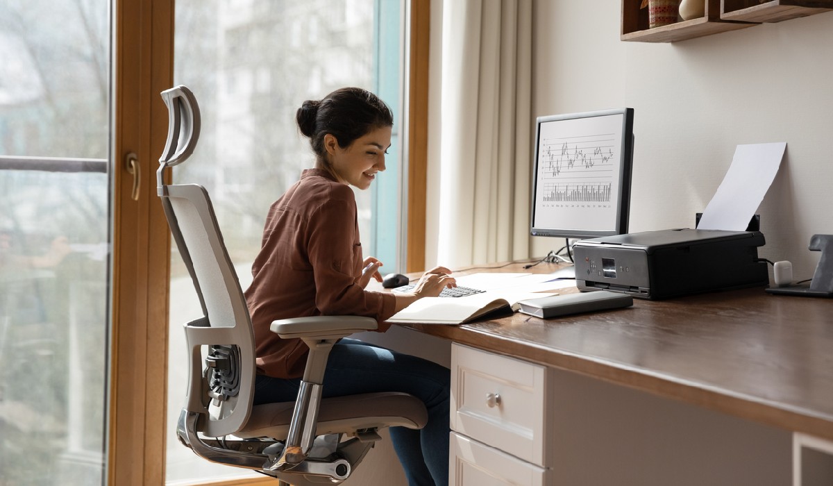 swivel chairs independence Concentrated young indian ethnicity woman sitting in comfortable adjustable ergonomic armchair
