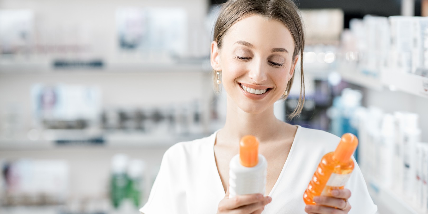 affordable-drugstore-makeup the-independence Young woman customer choosing sunscreen lotion at the pharmacy store