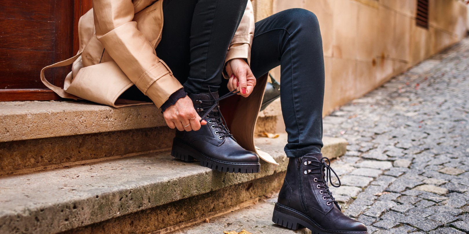 ankle-boots-with-jeans the-independence Stylish woman tying shoelace of black ankle boot
