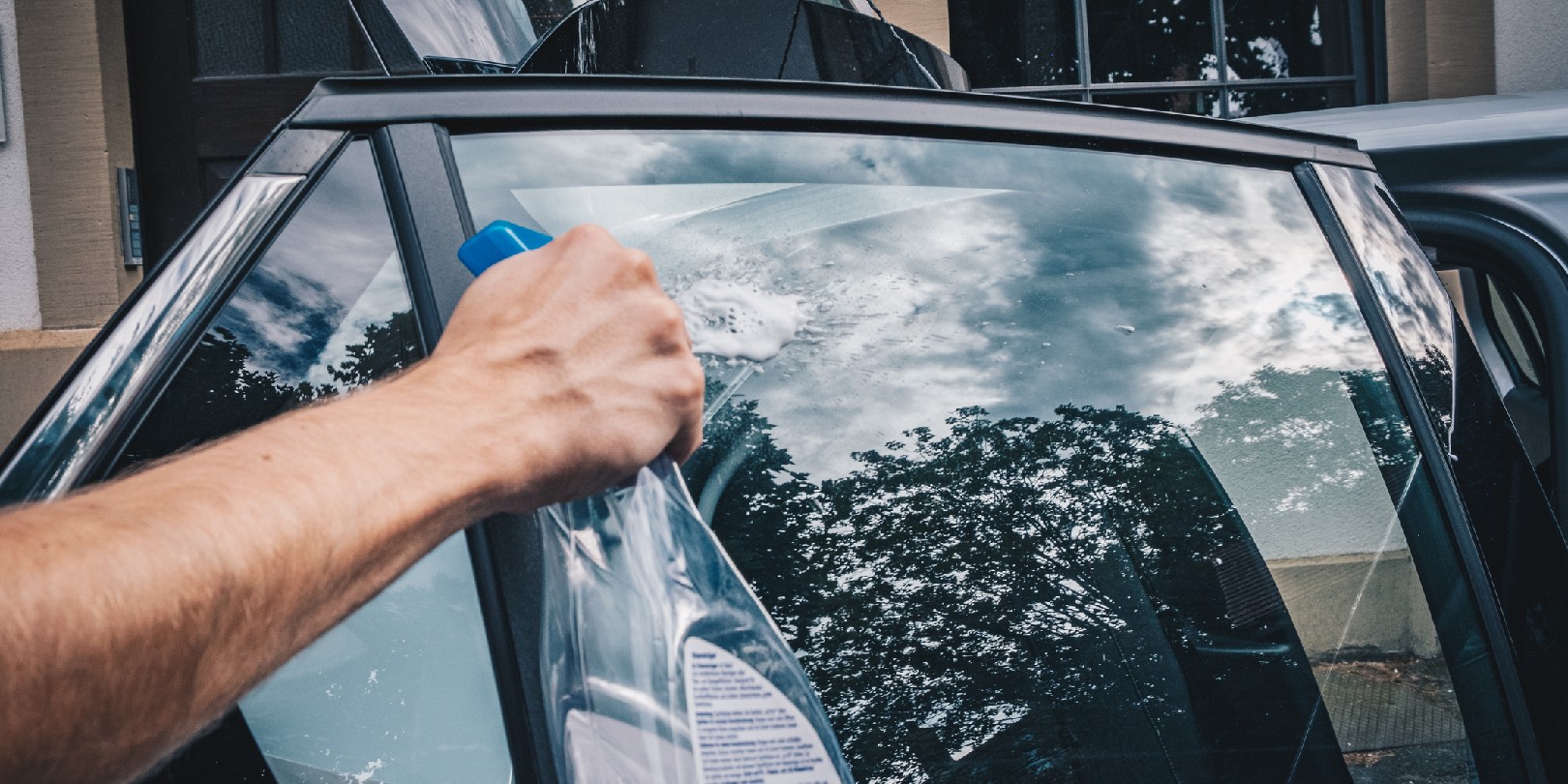 Young man cleans his electric vehicle