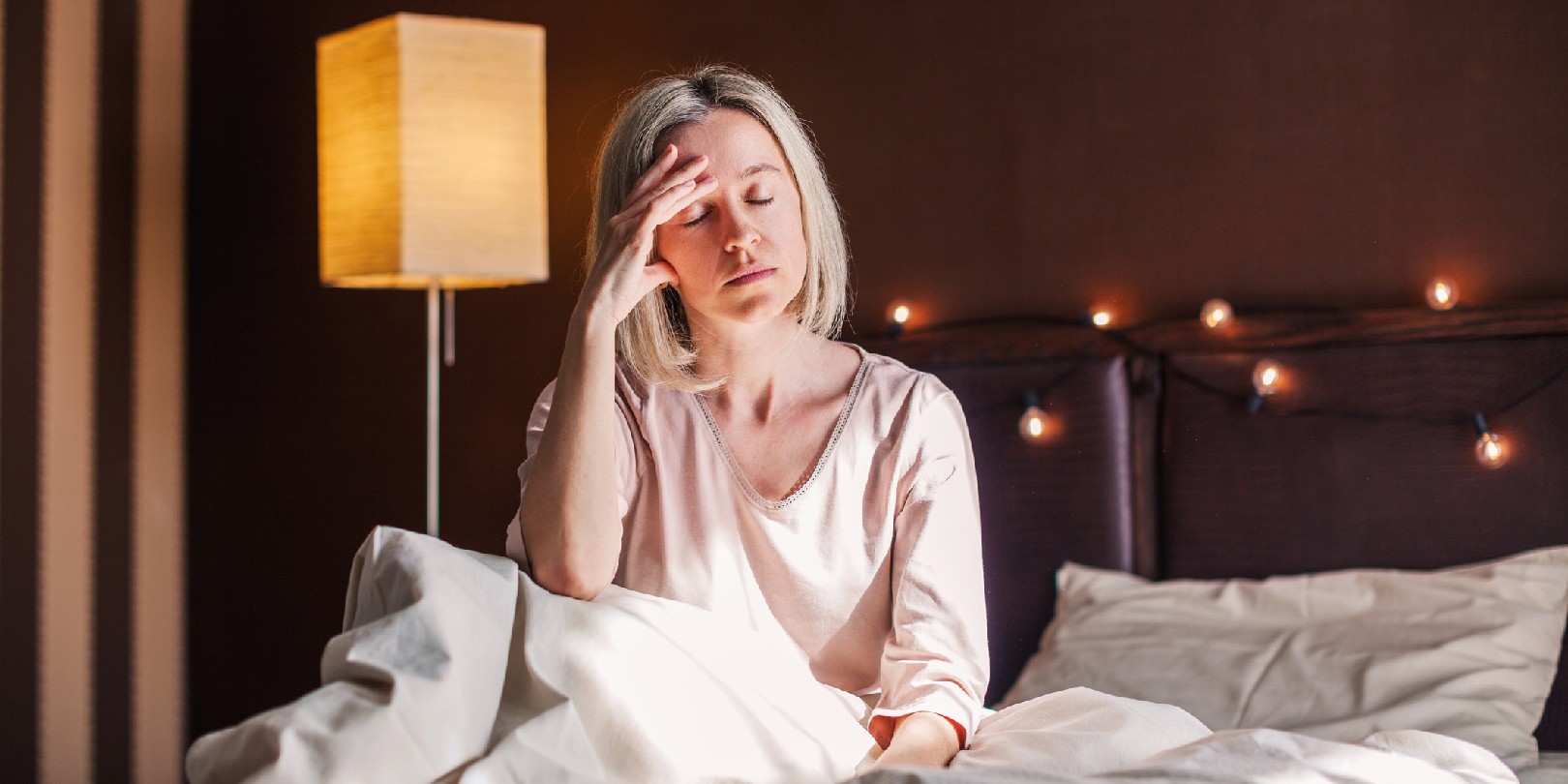 effects-of-skipping-sleep the-independence After sleepless night sad 40s woman got up sit on bed thinking