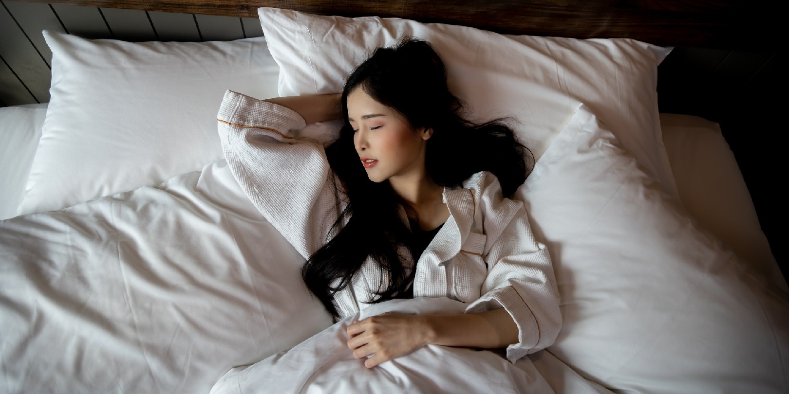 Top View of Beautiful Young Asian Woman sleeping cozily on bed at bedroom on night with sweet dream and sleep well