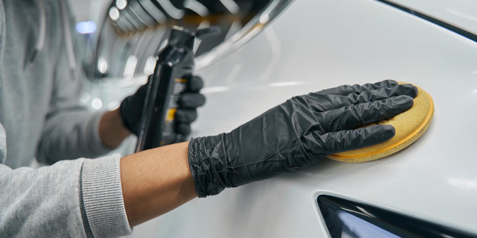 waxing-a-car the-independence Cropped photo of experienced worker in protective gloves waxing exterior auto body panel