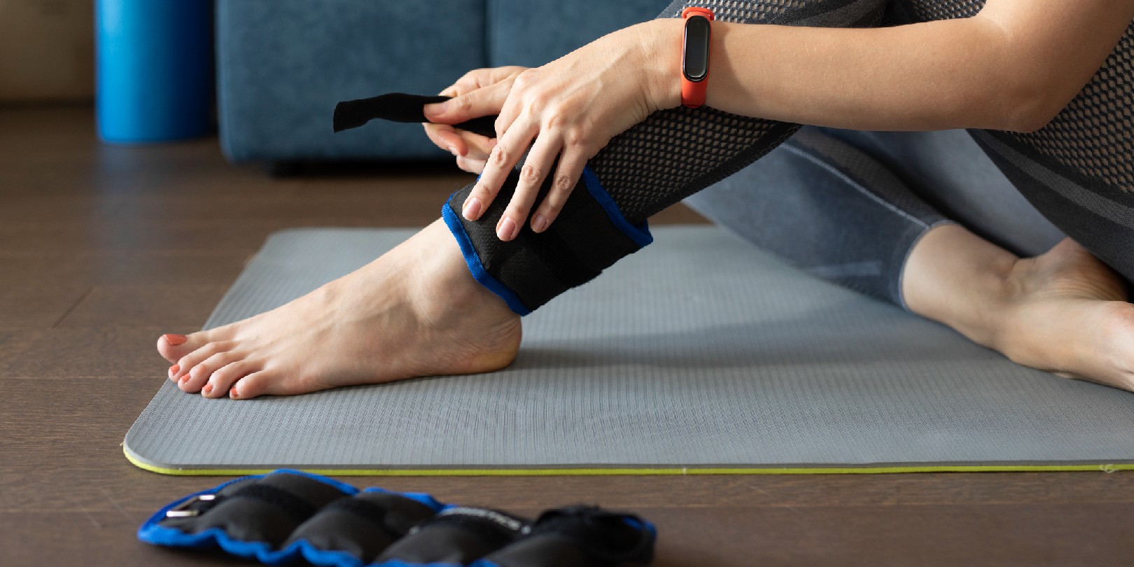 ankle-mobility-exercises the-independence Anonymous woman putting ankle weights on her legs to work out at home.