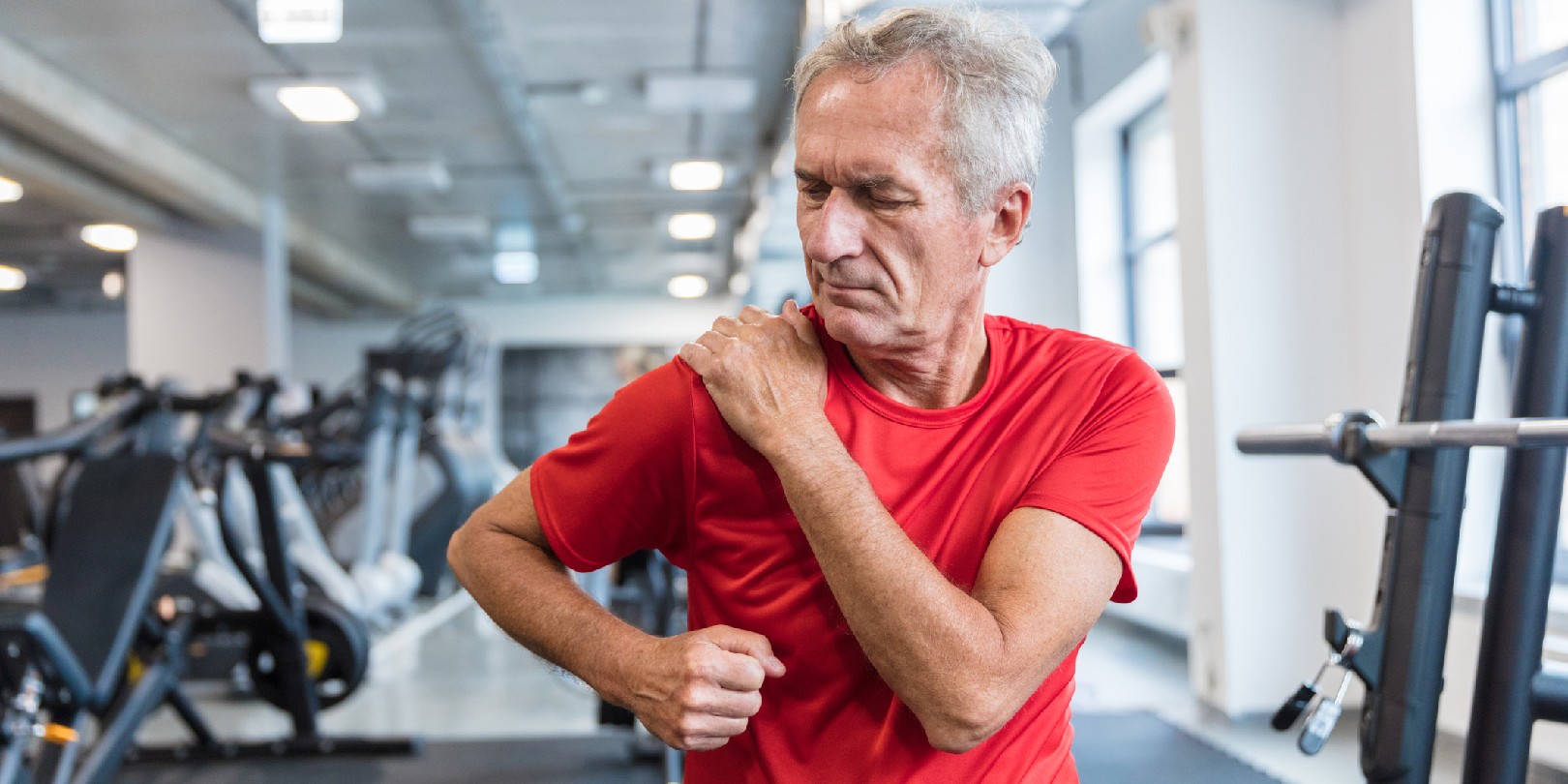 are-sore-muscles-good-sign the-independence Mature man feeling pain in his shoulder during workout at rehabilitation center.