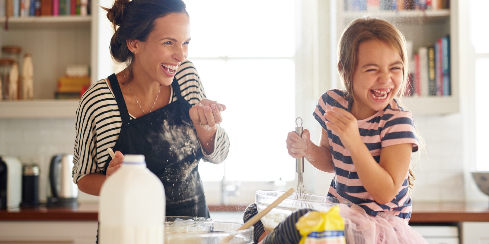 Shot of a little girl having fun baking with her mother in the kitchen
