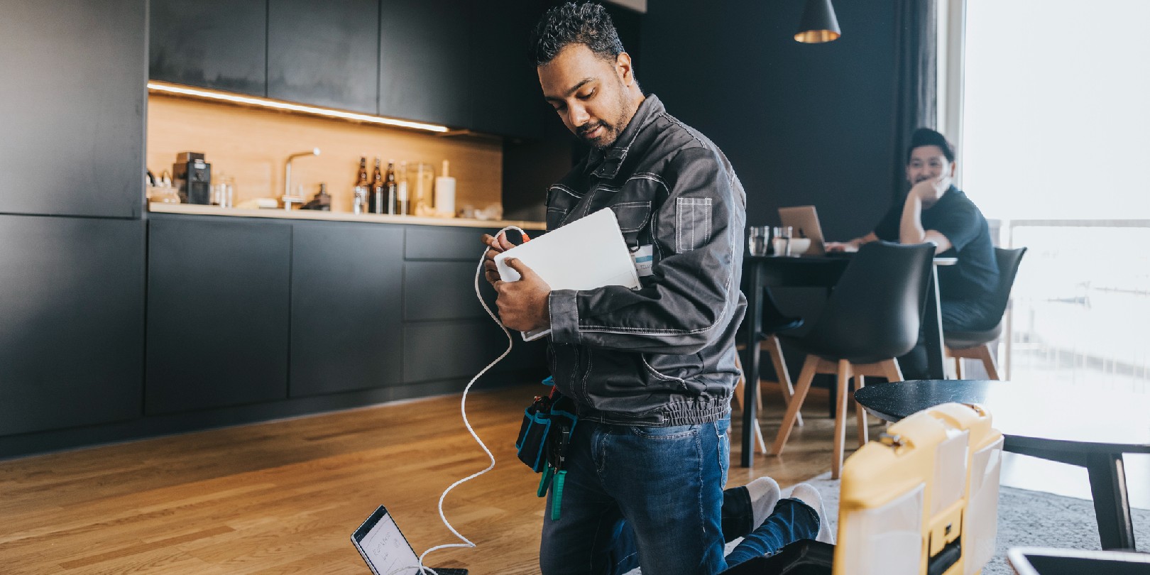 Indian technician installing wifi router at customers house.