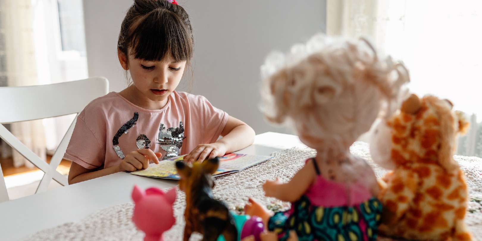 mystery-books-for-kids the-independence Cute little kid girl playing alone reading book to toys