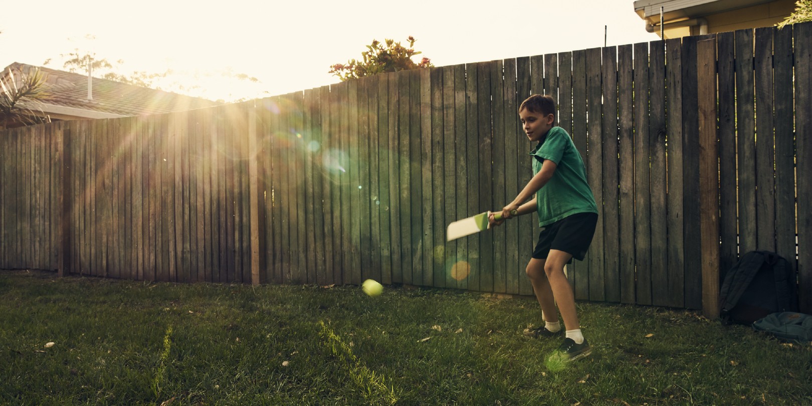 Shot of a young boy playing by himself in the backyard