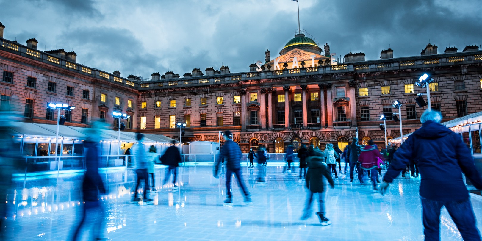 Blurred motion of crowds of people ice skating at Somerset House, a publically owned building in central London