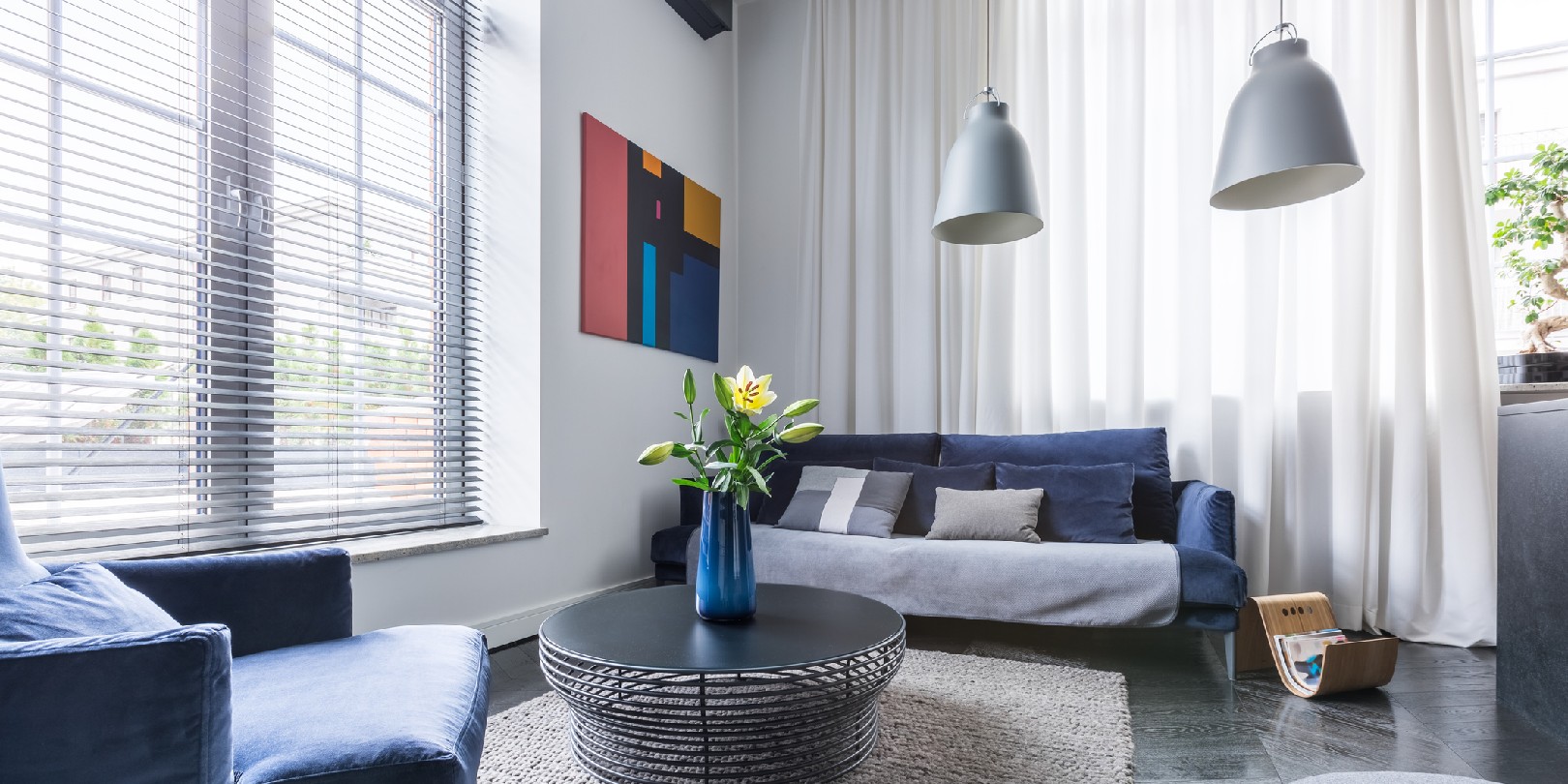 small-living-room-ideas the-independence Living room with blue upholstered furniture, window blinds and white net curtain