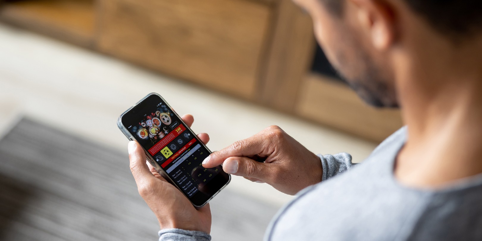 sports-betting the-independence Man gambling online on a football match using his cell phone - lifestyle concepts