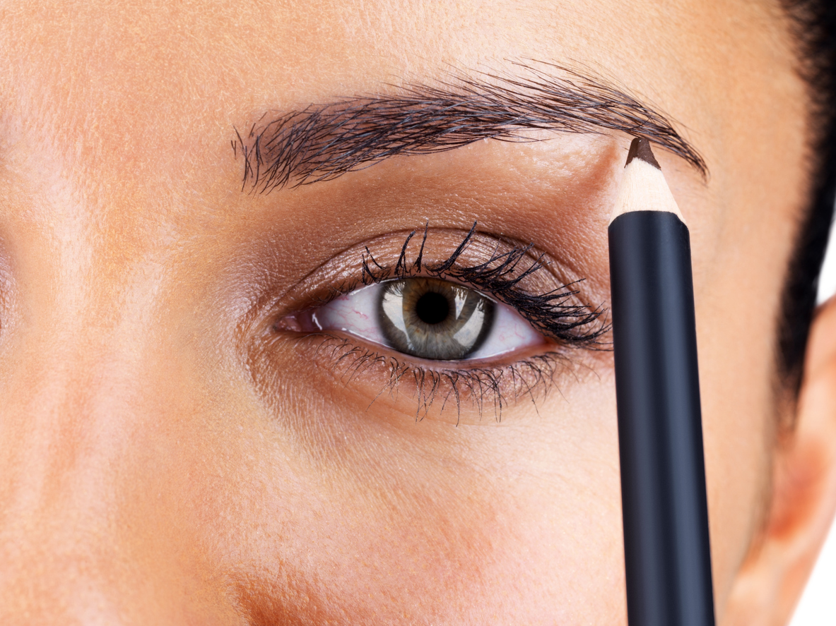 Attractive woman applying eyebrow pencil can eyebrow pencil cause hair loss?