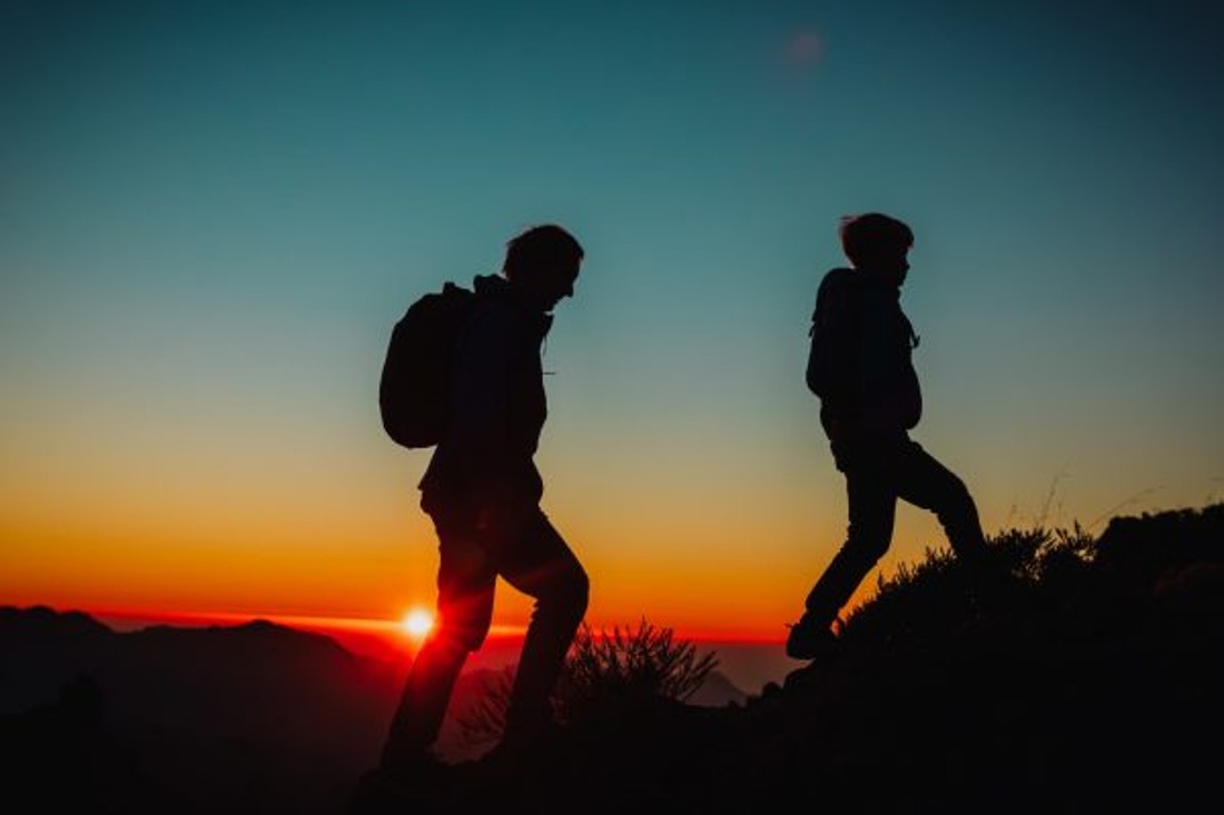 silhouettes-of-father-and-son-hiking-in-mountains-at-sunset-theindependence Father and son hiking at night